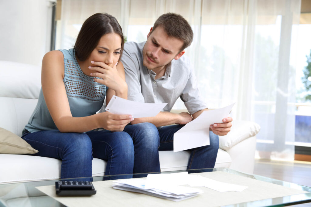 Young couple reviewing their foreclosure notice | How long does a timeshare foreclosure stay on your credit?