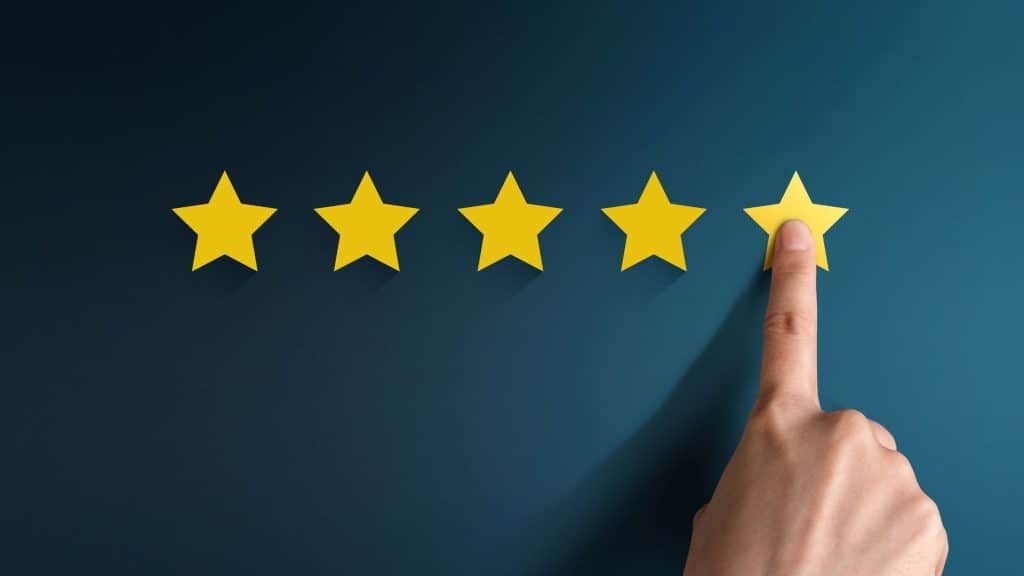 Finger Pokes One of Five Yellow Stars Over Blue Background | Pros and Cons of Wesley Financial Group
