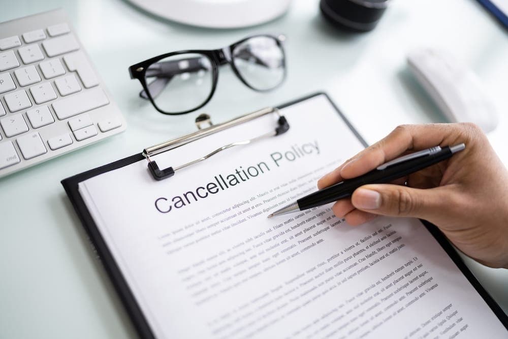 Someone reading along a cancellation policy with a pen | California Timeshare Cancellation
