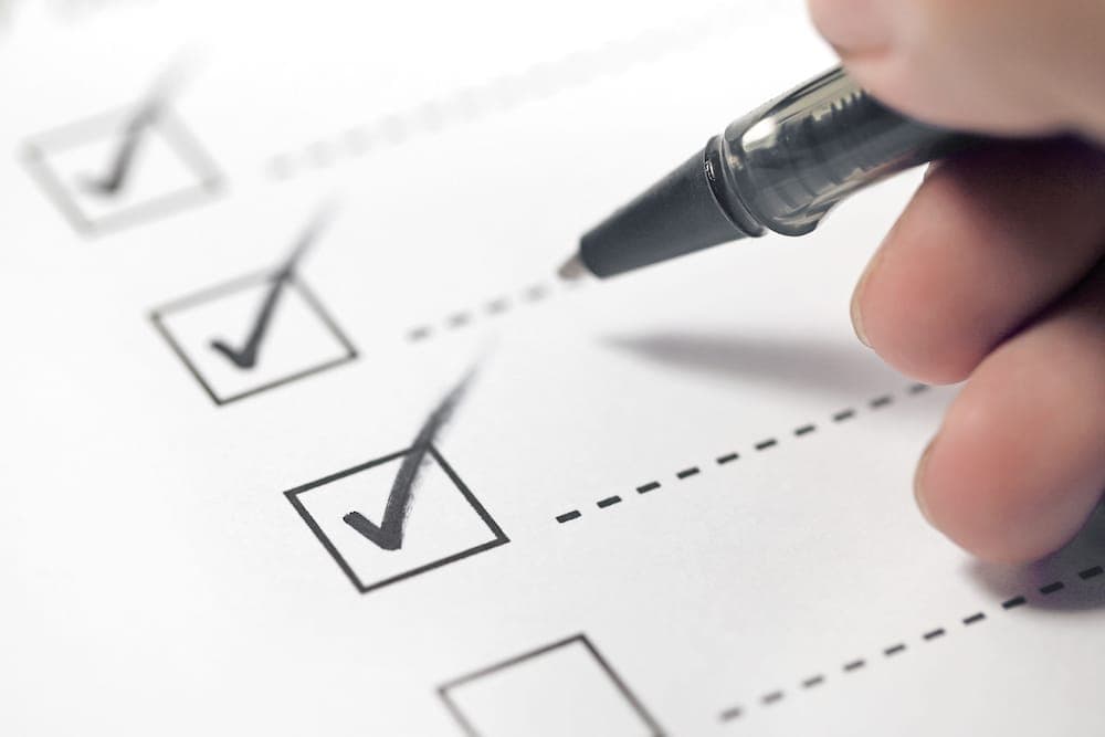 Checking off a checklist with a pen | Florida Timeshare Cancellation
