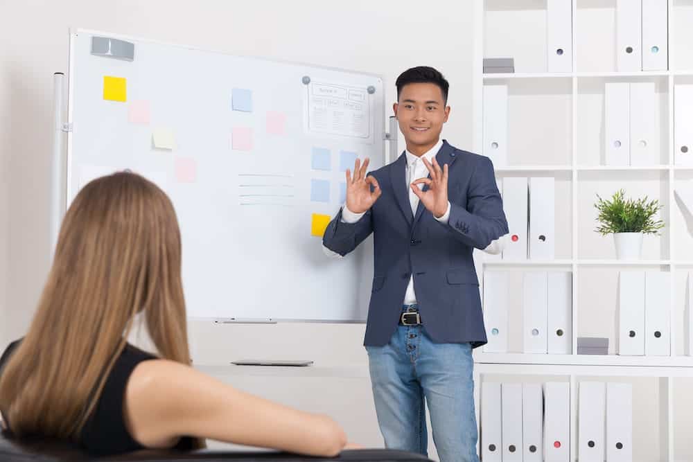 Man in suit lecturing during a presentation | Arizona timeshare cancellation