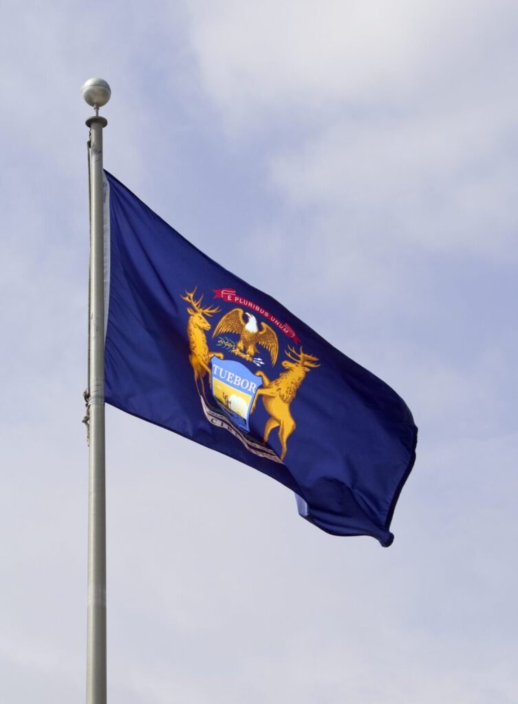 Michigan state flag waving in the wind | Michigan timeshare cancellation