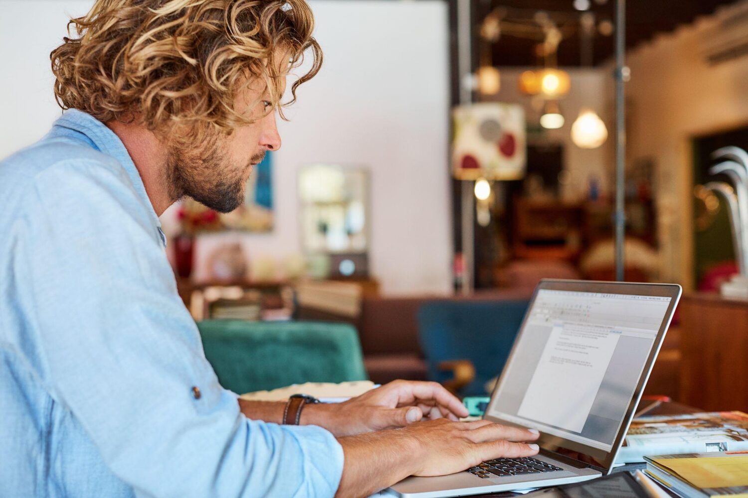 Man on a laptop at a collection agency | What happens when you default on a timeshare?