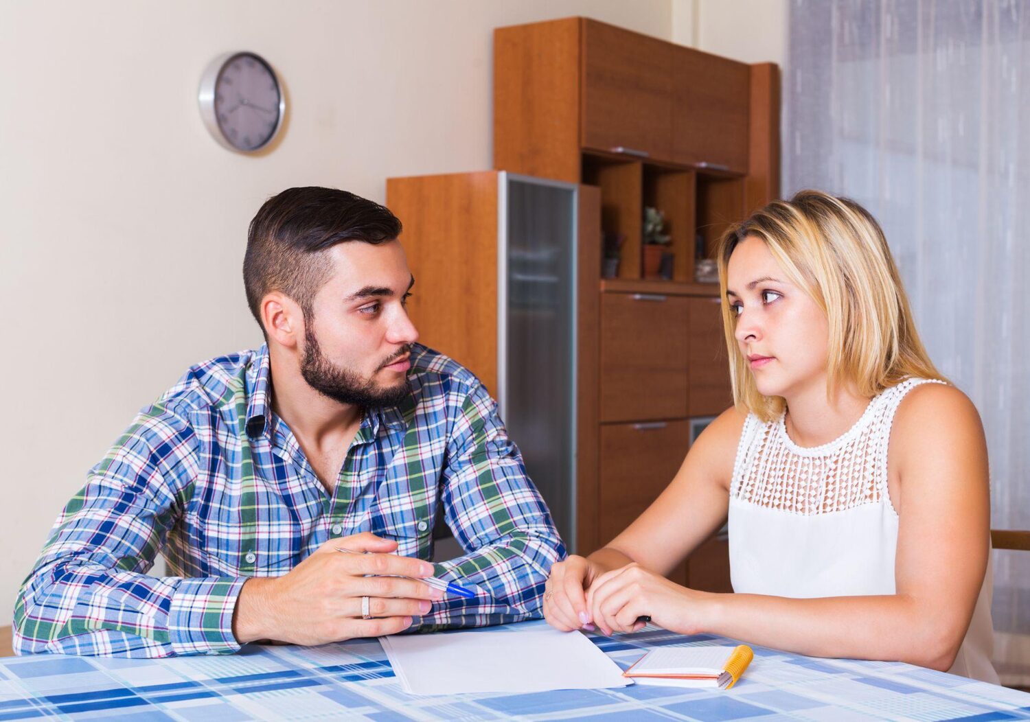 Worried couple discussing their future | What happens when you default on a timeshare?