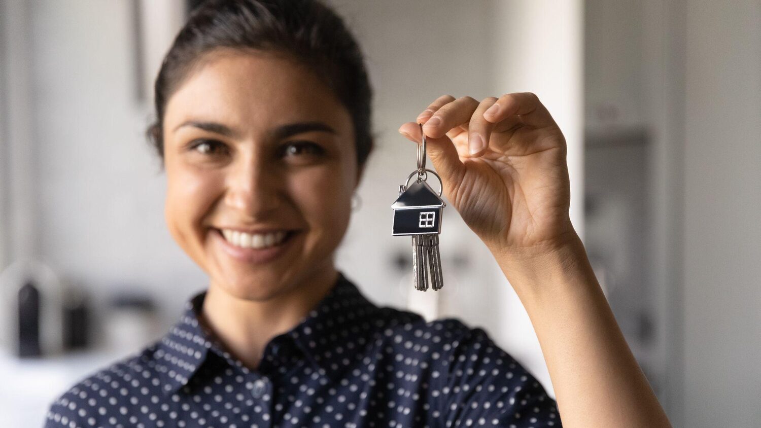 Lady holding keys to the property | Who buys timeshares?
